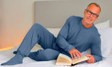 Man lying on bed in comfortable blue bamboo eczema pyjamas